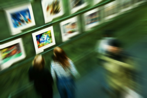 Abstract zoom image of people visiting art museum stopping by a picture